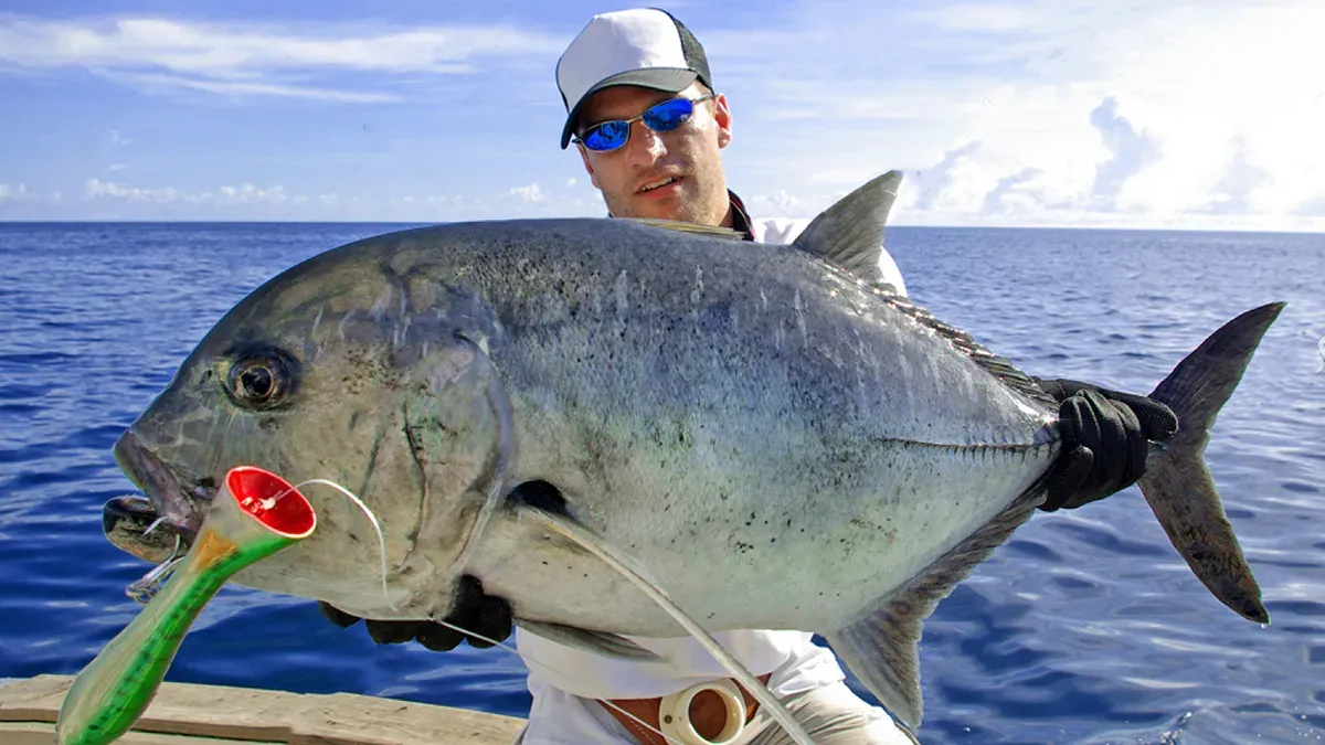 Master the Art of Catching Giant Trevally: Ultimate Australia Guide 8 Proud angler with a giant trevally catch of the day!